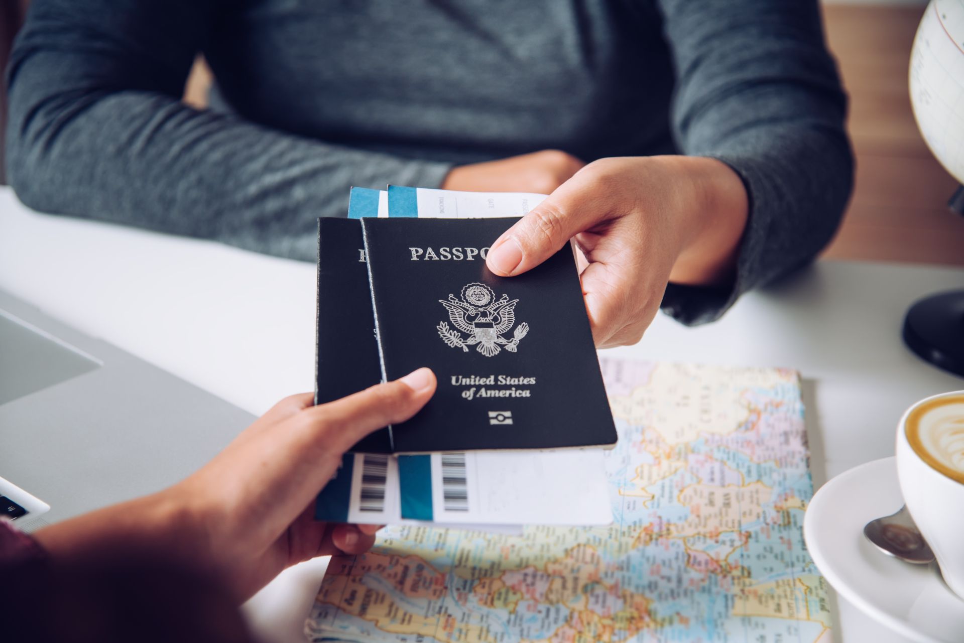 Close-up of US passport with inflight magazine and headphones on an airplane seat, ready for travel.